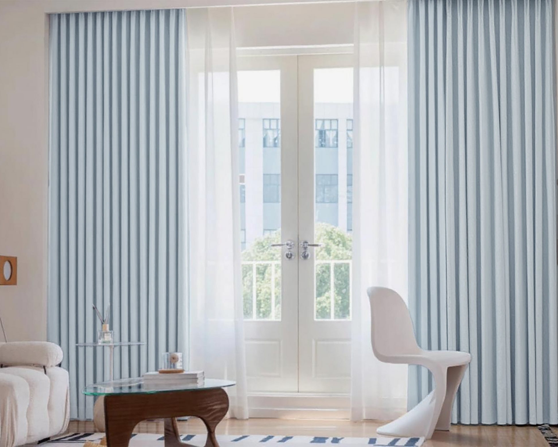 Modern interior with striped curtains and a white chair.