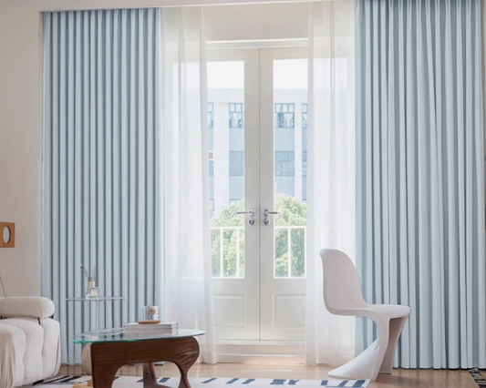 Modern interior with striped curtains and a white chair.