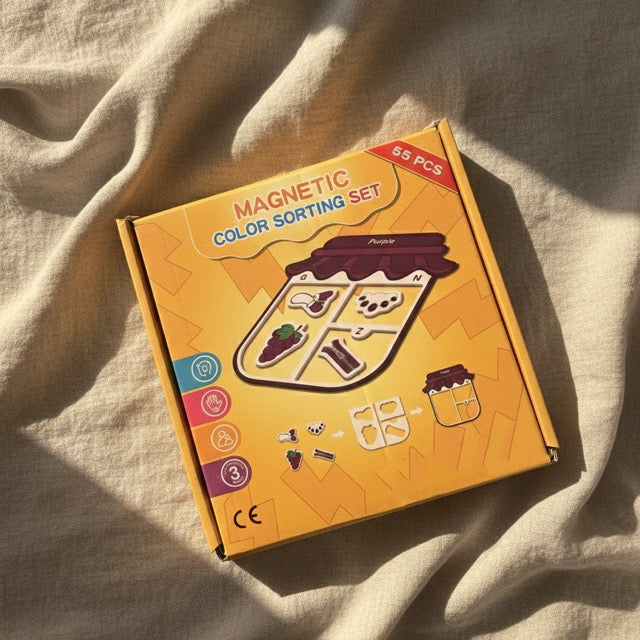 Box of a magnetic color sorting set on a beige fabric background