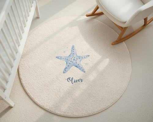 Round beige rug with a blue starfish design and 'Oliver' text in a nursery setting.