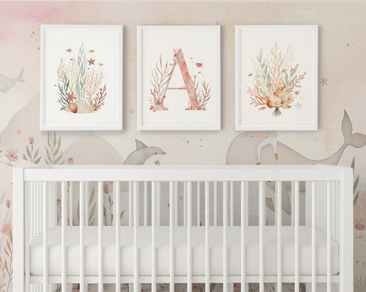 Nursery room with a crib and wall art featuring coral and letter 'A'.