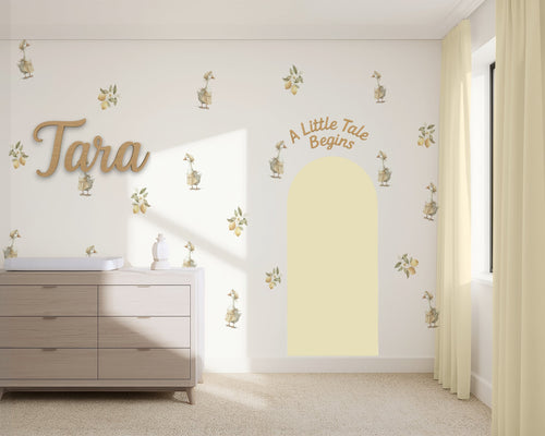 Nursery room with decorative wall stickers and a dresser.