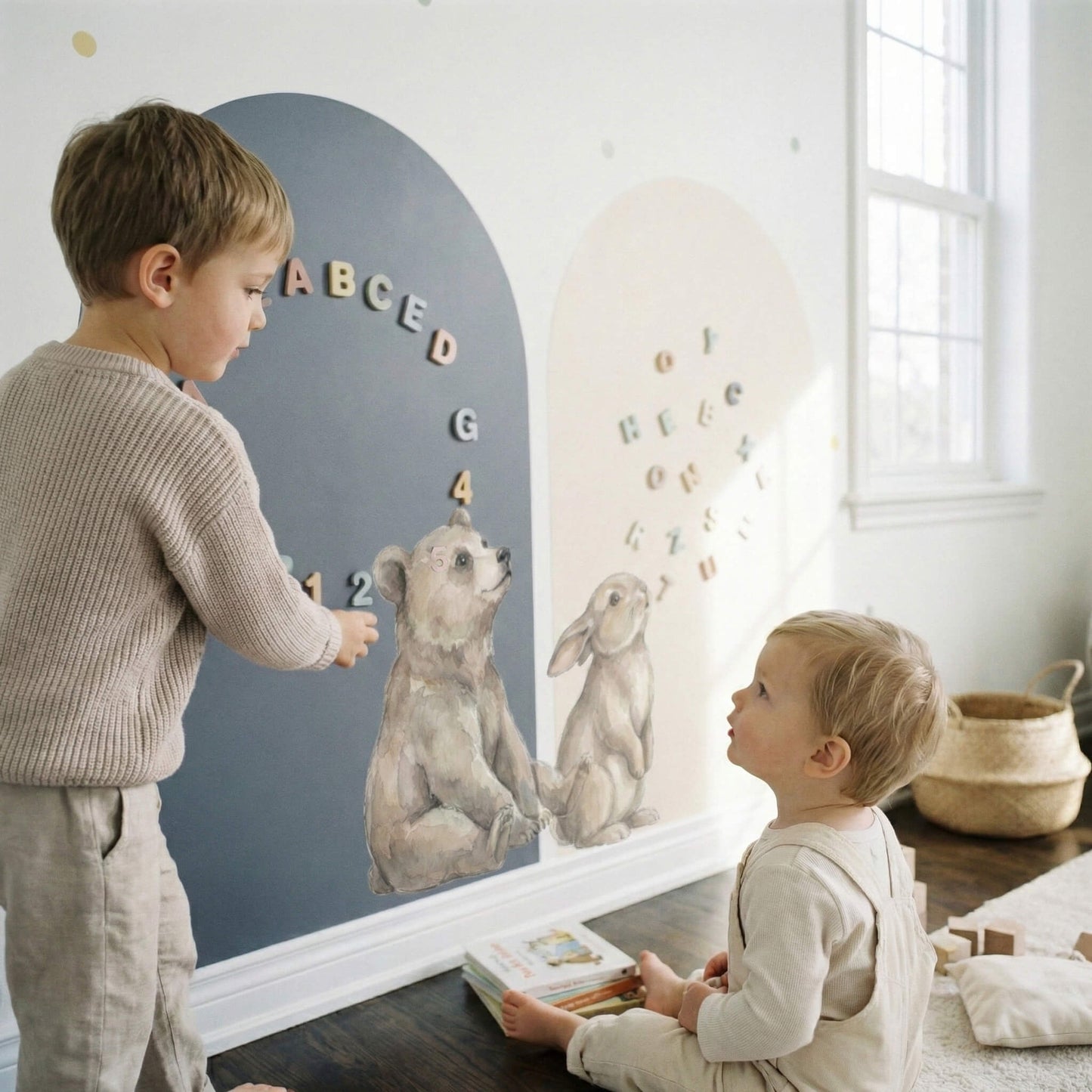 Interactive toddler play wall with watercolor bear and bunny characters on matte arch panels and pastel atmosphere dots