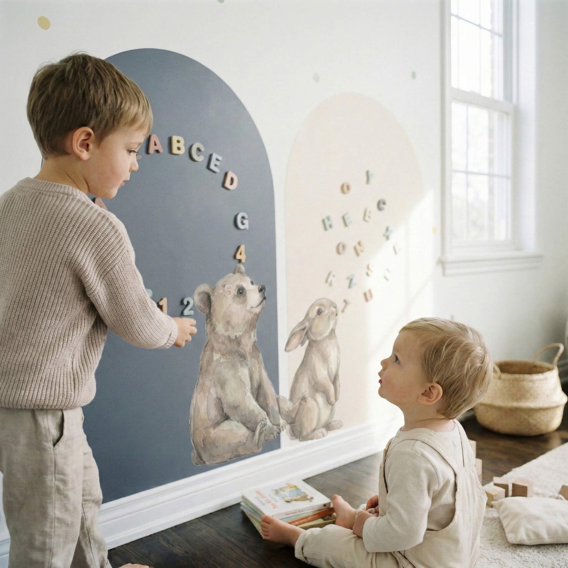 Interactive toddler play wall with watercolor bear and bunny characters on matte arch panels and pastel atmosphere dots