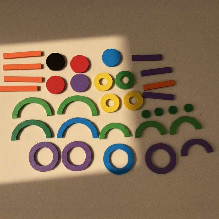 Neatly arranged magnetic shapes showing bars, rings, and circles in multiple colors.