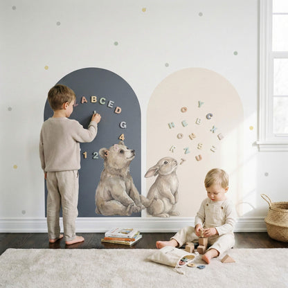 Montessori magnetic story wall with bear and bunny arch panels, soft atmosphere dot stickers, and toddlers playing with alphabet magnets in a Scandinavian nursery