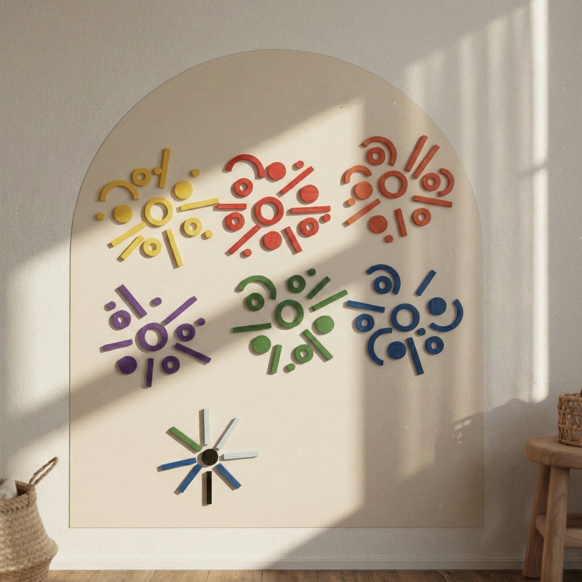 Geometric patterns created with magnetic shapes on a large cream-colored arch wall canvas.