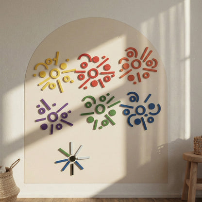 Geometric patterns created with magnetic shapes on a large cream-colored arch wall canvas.