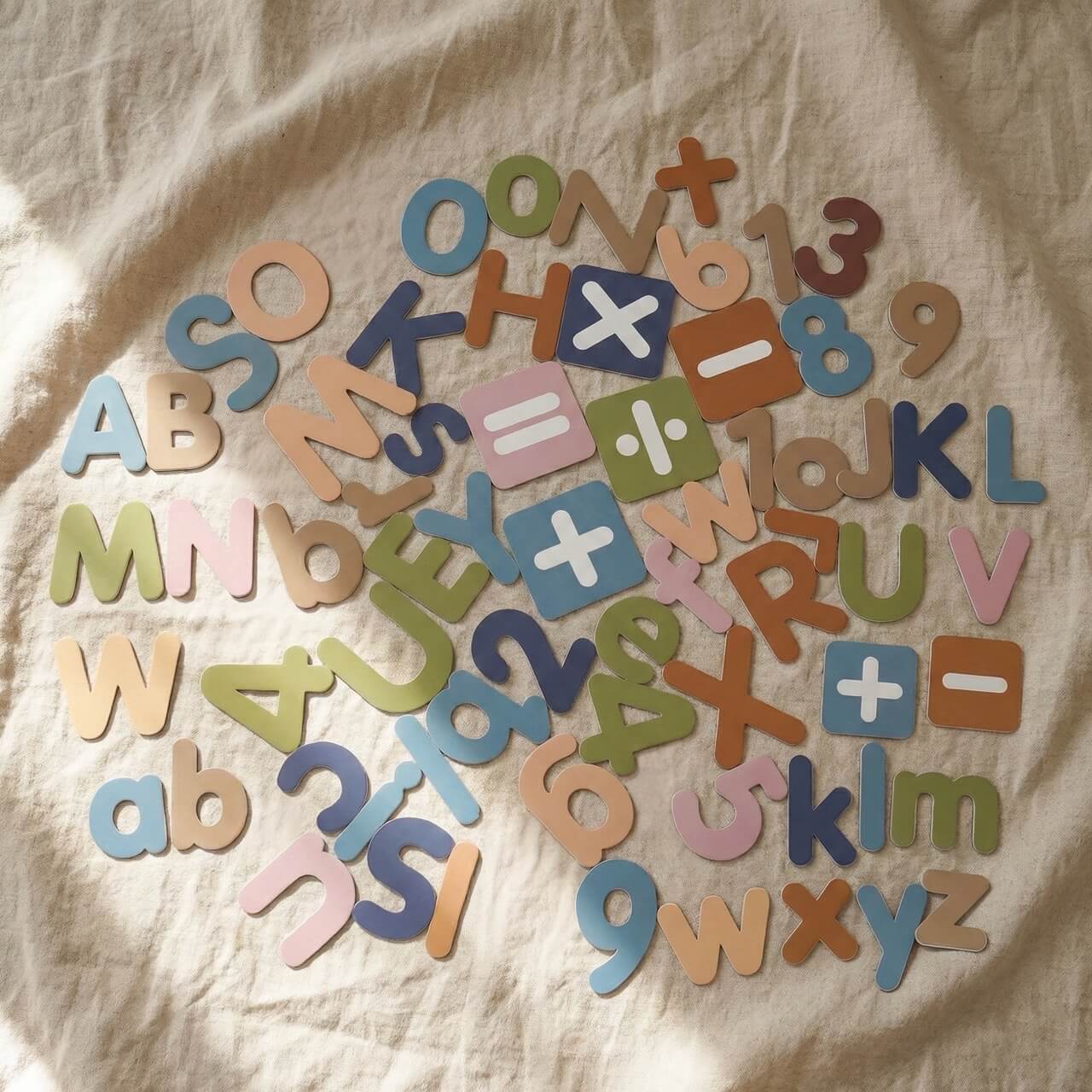 Complete Montessori magnetic alphabet, numbers and math symbols learning set on natural fabric background