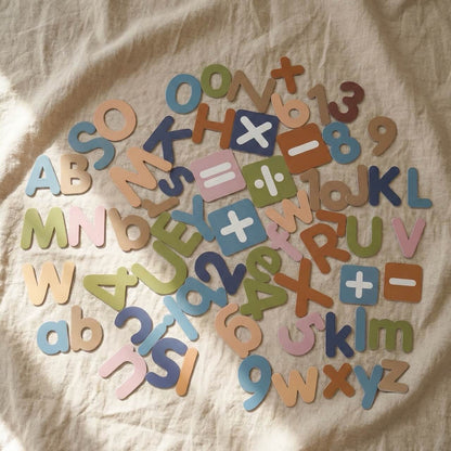 Complete Montessori magnetic alphabet, numbers and math symbols learning set on natural fabric background