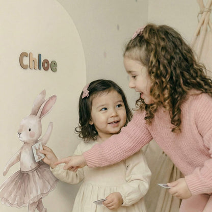 Children playing together on magnetic wall with story character decals and tactile magnets